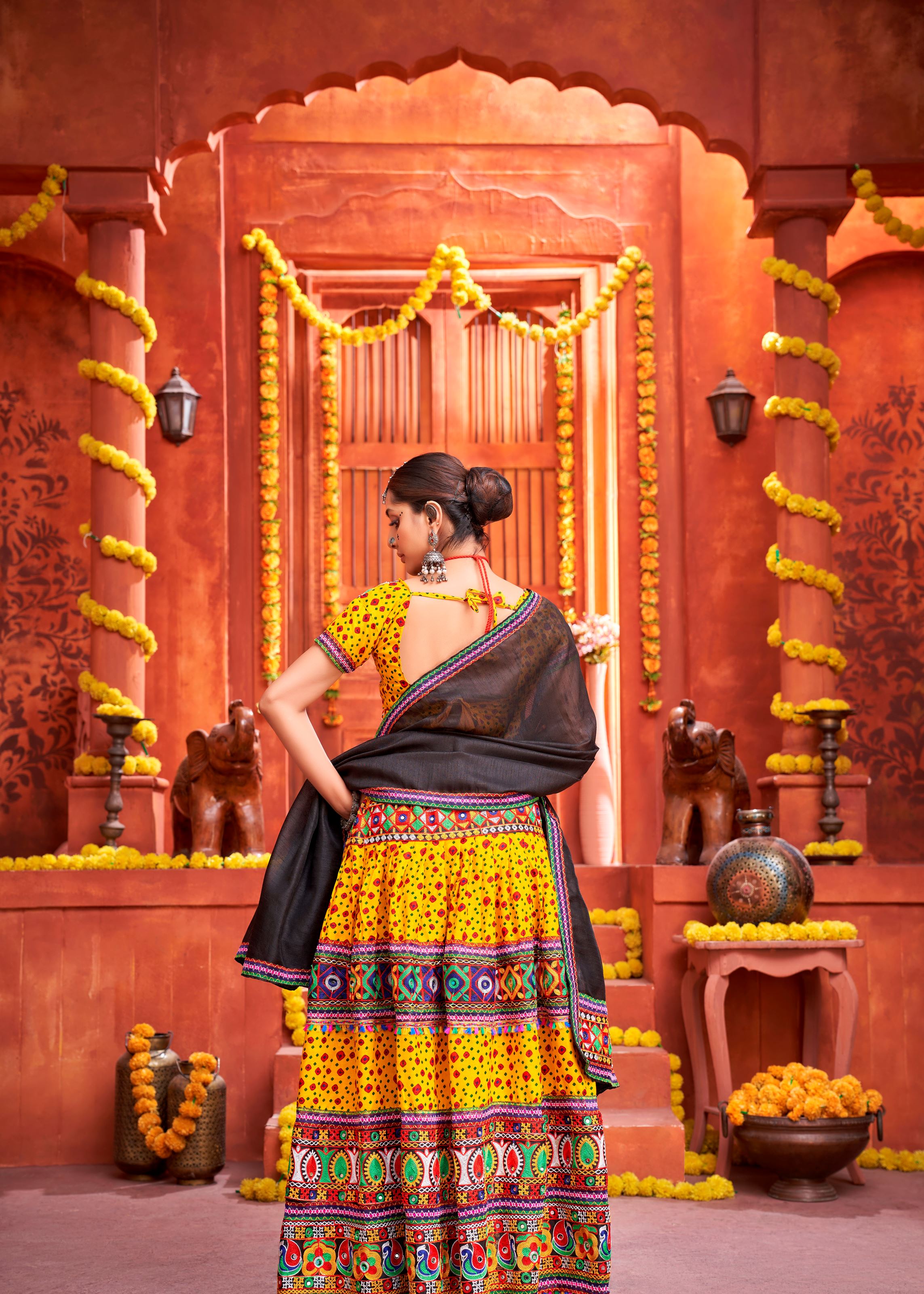 Yellow And Black Navratri Chaniya Choli With Patola Print And Gamthi Work And Real Mirror Work